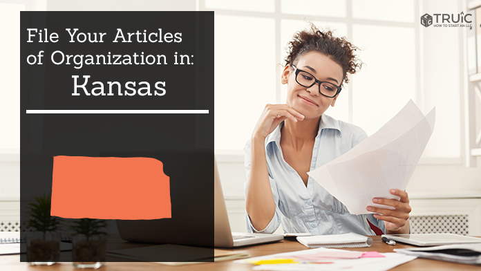 Woman smiling while looking at her articles of organization for Kansas.