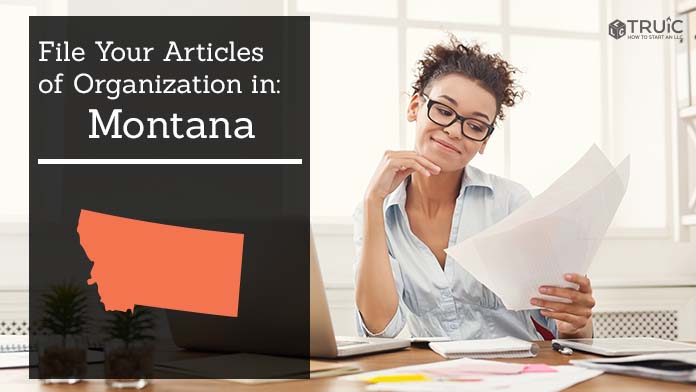 Woman smiling while looking at her articles of organization for Montana.