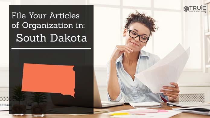 Woman smiling while looking at her articles of organization for South Dakota.